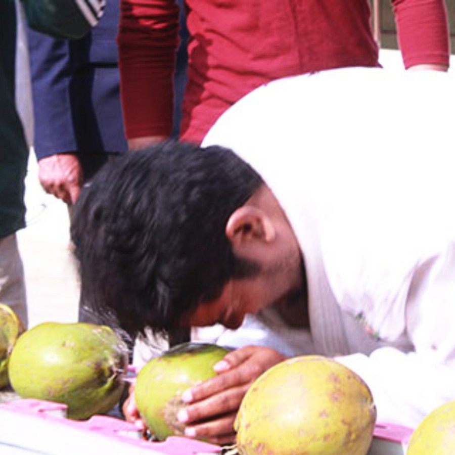 Most Green Coconuts Smashed on Head in One Minute
